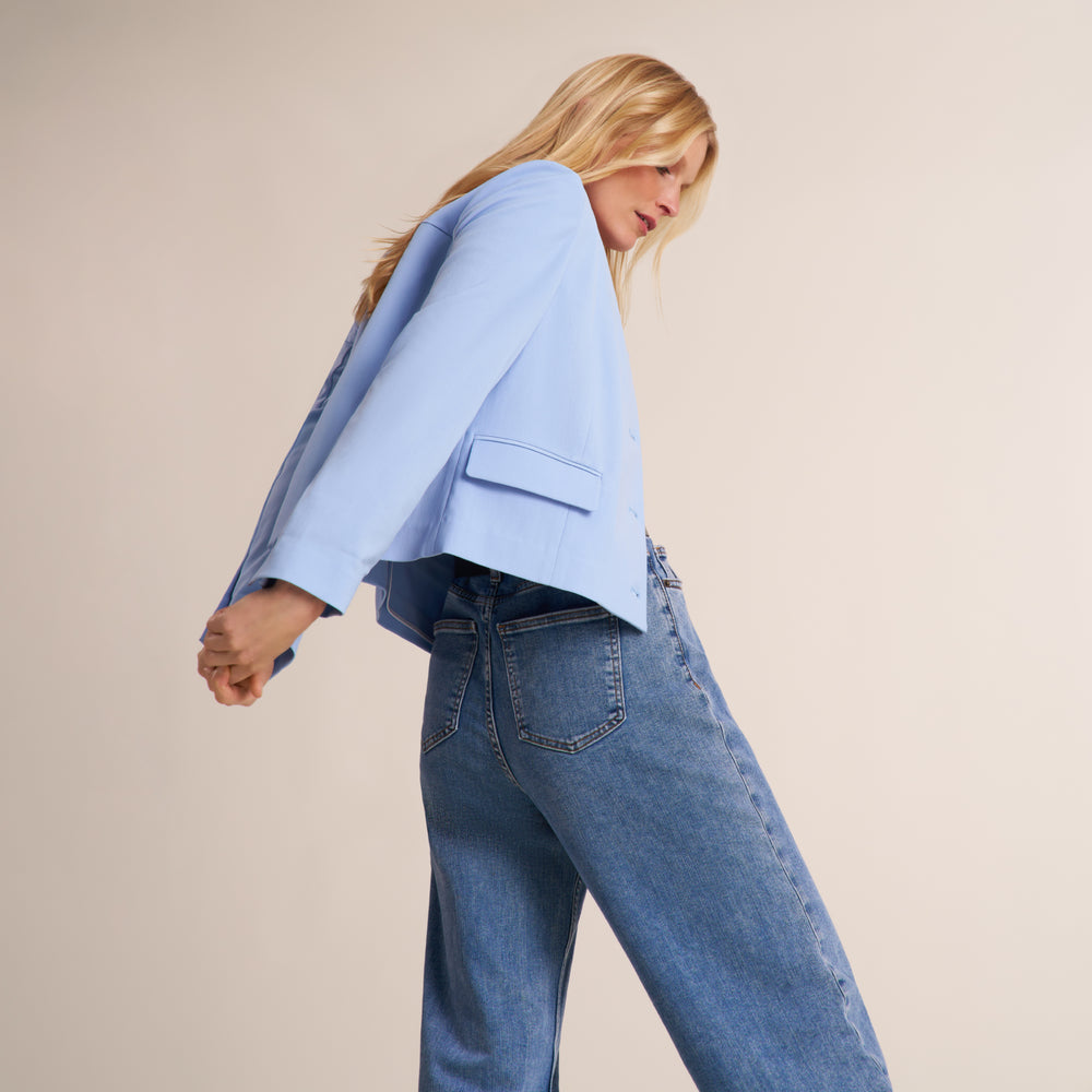 Detail image of a woman wearing the Aniya Jacket in light blue