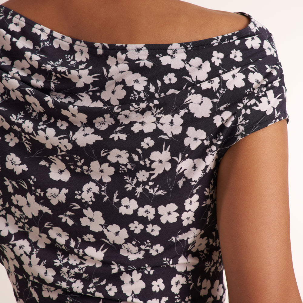 Woman wearing a floral off the shoulder top and jeans