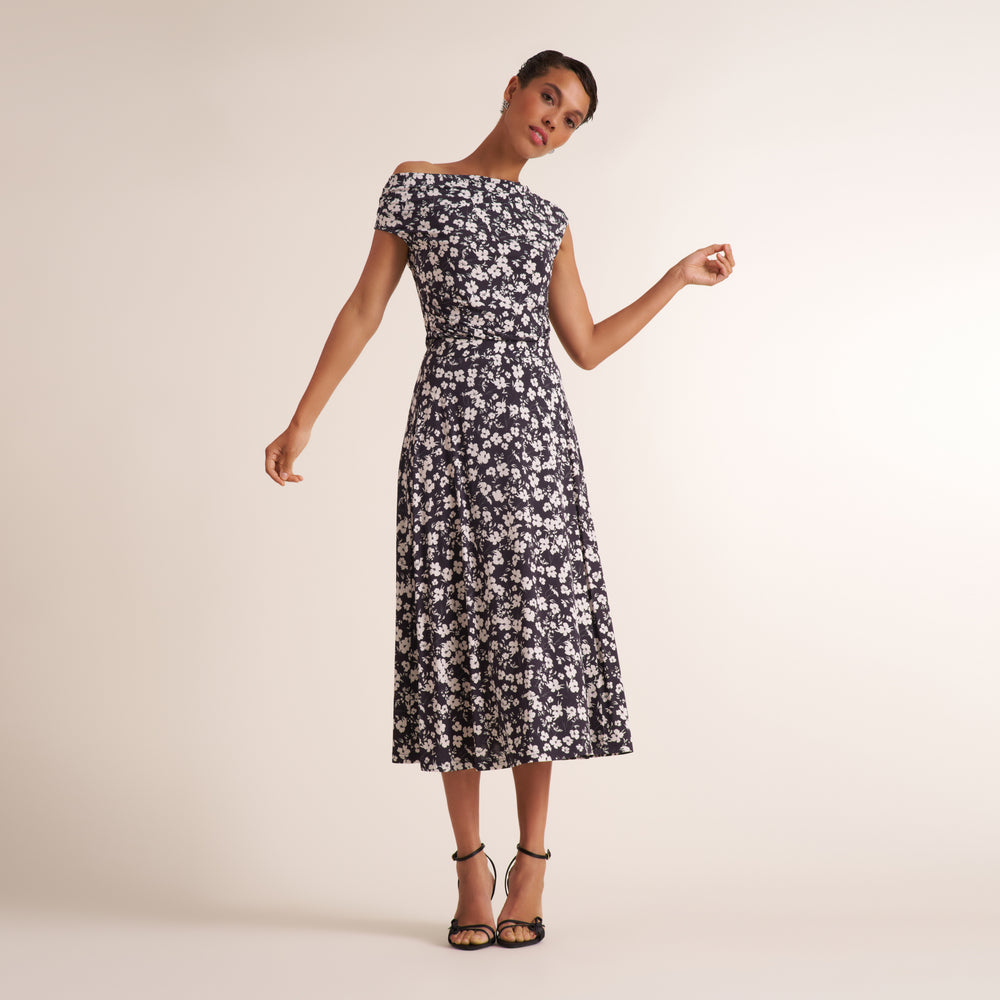 Woman wearing a matching shirt and long skirt in a black and white matching floral print