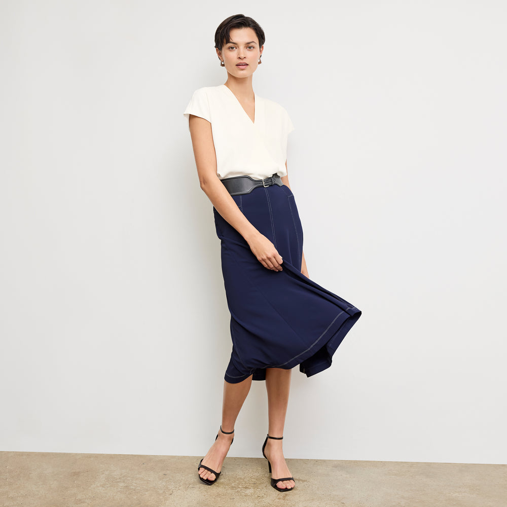 front image of a woman wearing the shannon skirt in soft navy