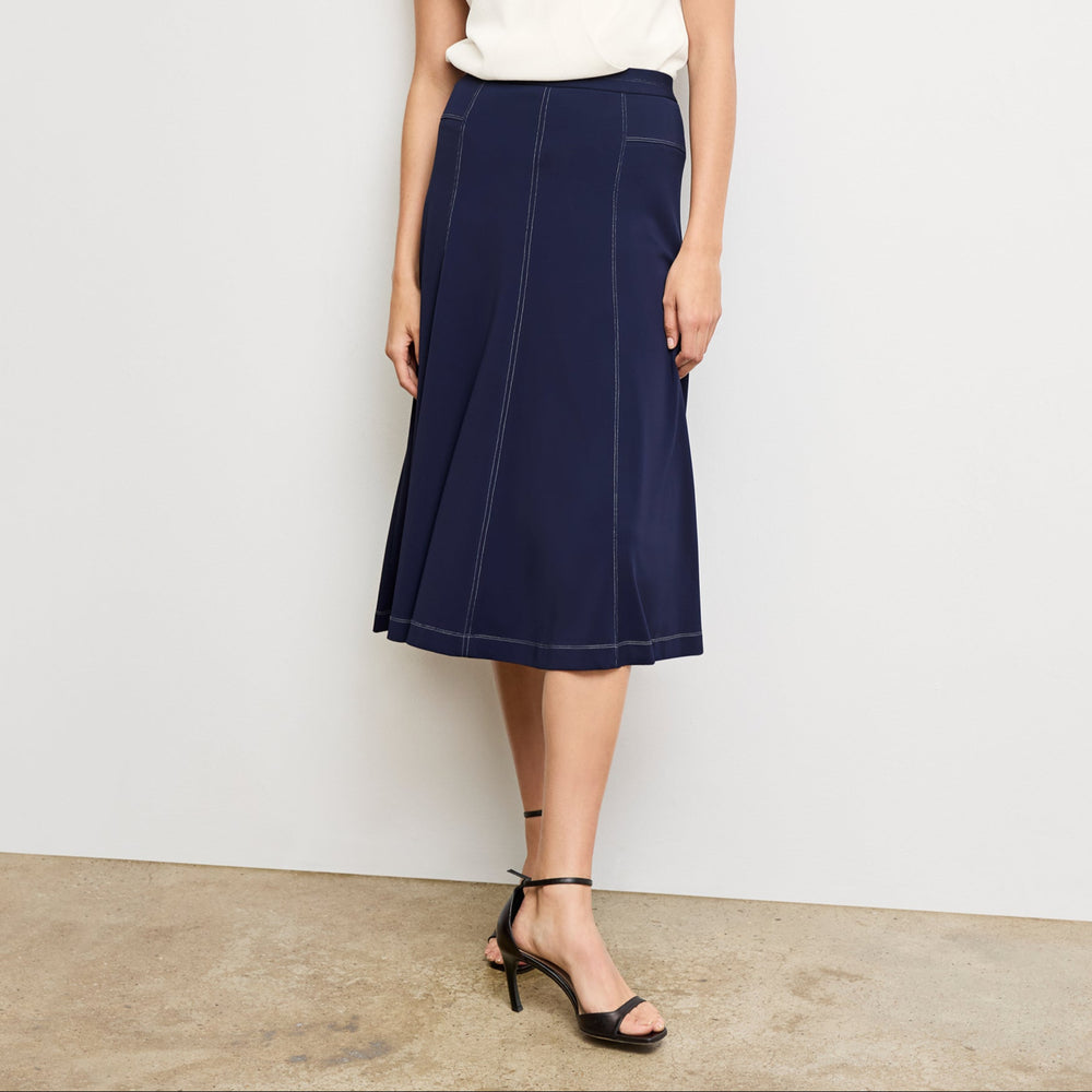 front image of a woman wearing the shannon skirt in soft navy