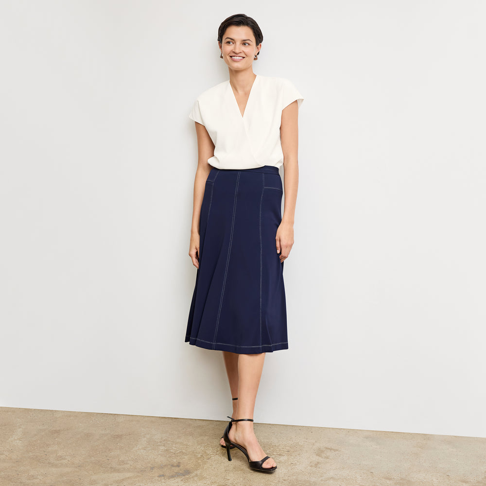 front image of a woman wearing the shannon skirt in soft navy