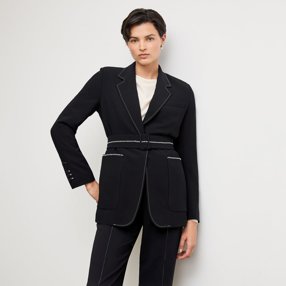front image of a woman wearing the athena blazer in black with topstitch
