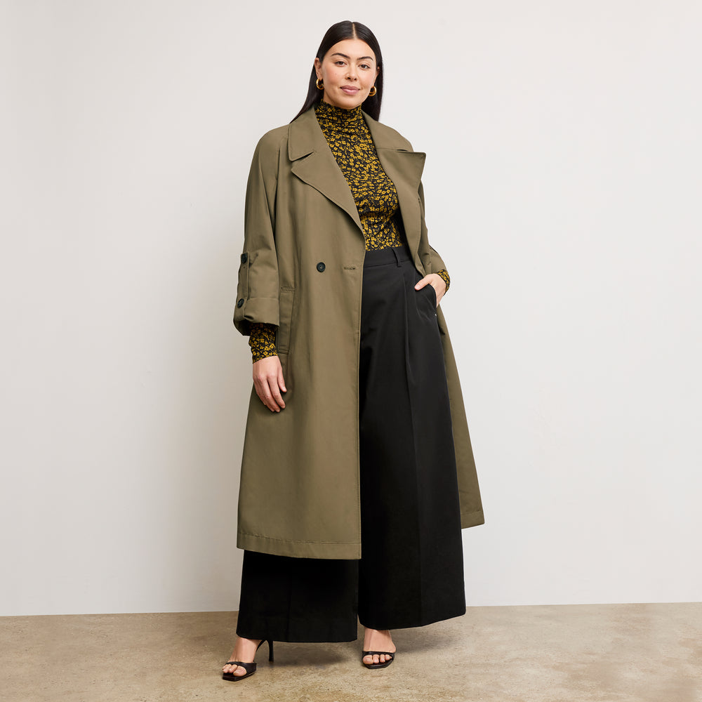 front image of a woman wearing the curtis trench in bancha green