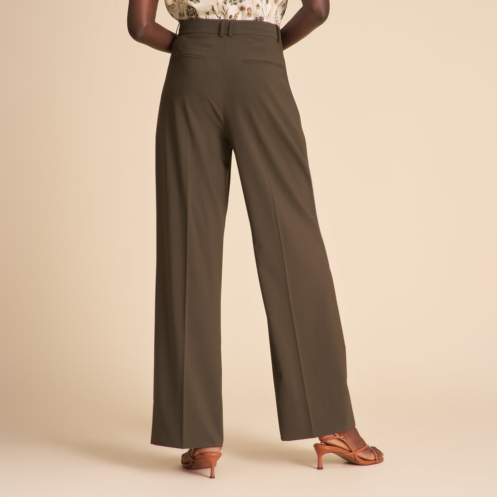 Brown wide-leg pants worn by a person on a beige background