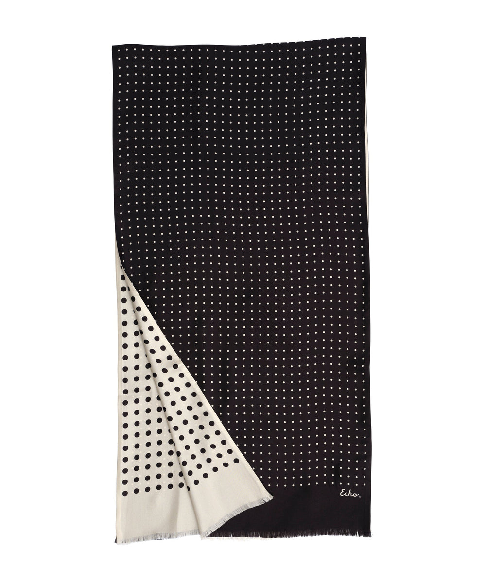 Black and white polka dot scarf with a brand logo on a white background