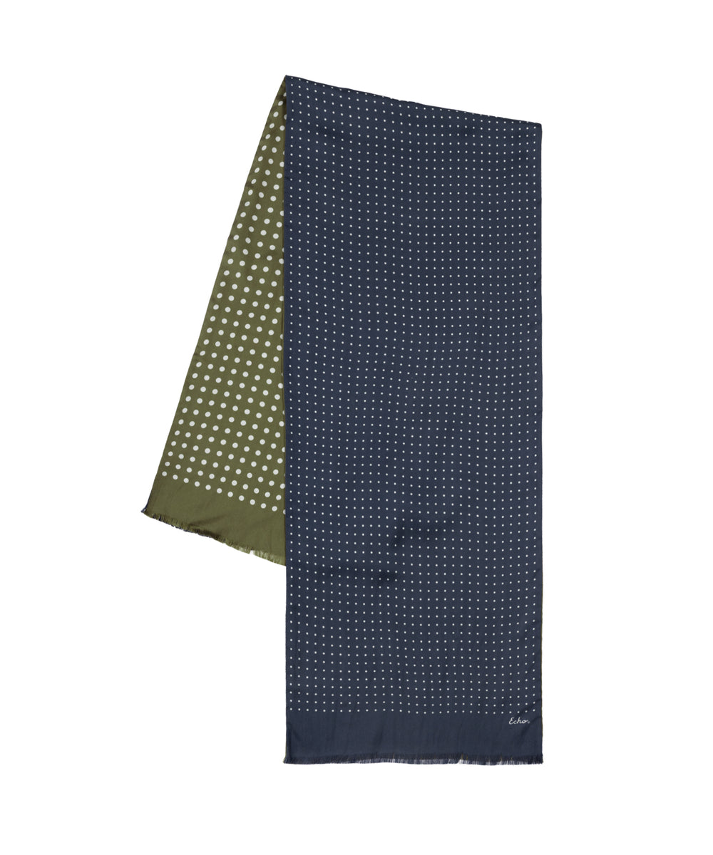 A folded navy blue scarf with a small white dot pattern, shown next to an olive green scarf with white polka dots, on a plain white background.