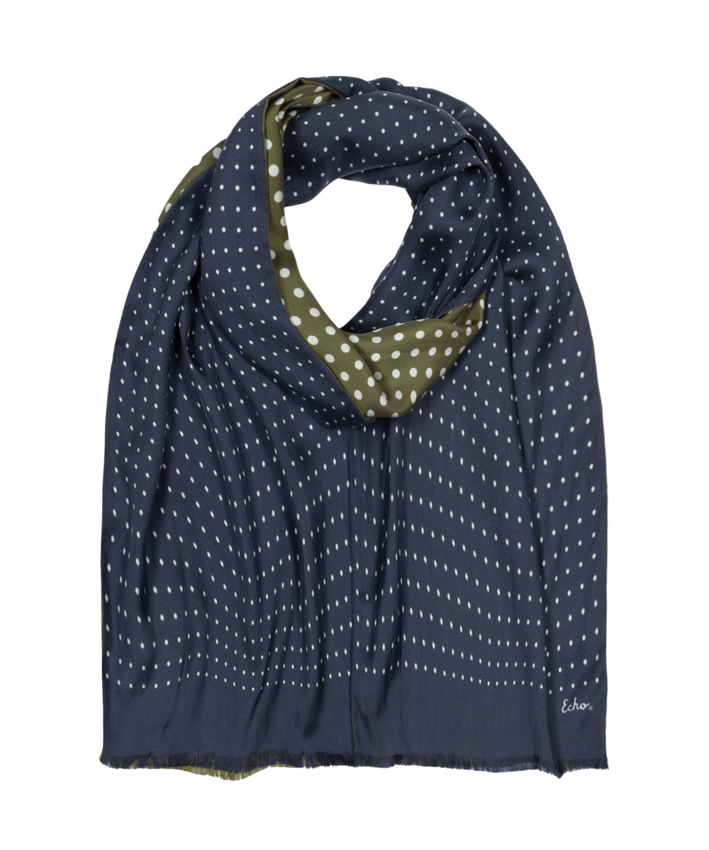 A navy blue scarf with a white polka dot pattern and a contrasting olive green inner lining, shown on a plain white background.