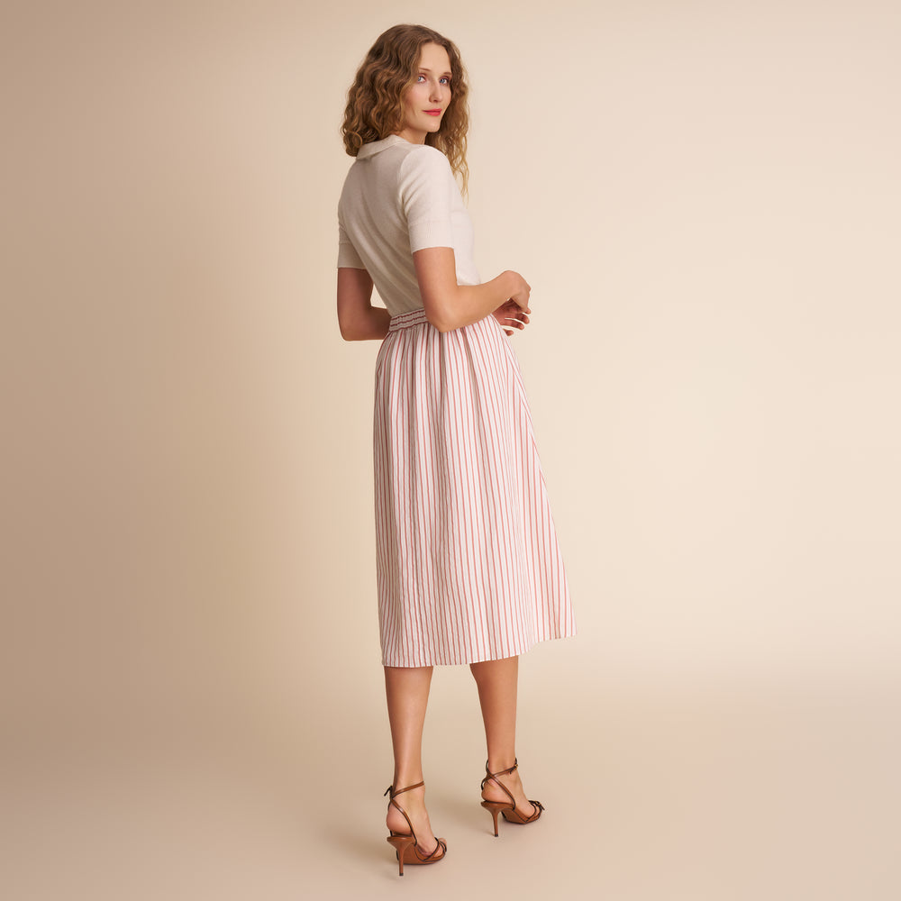 woman in white and orange stripped skirt