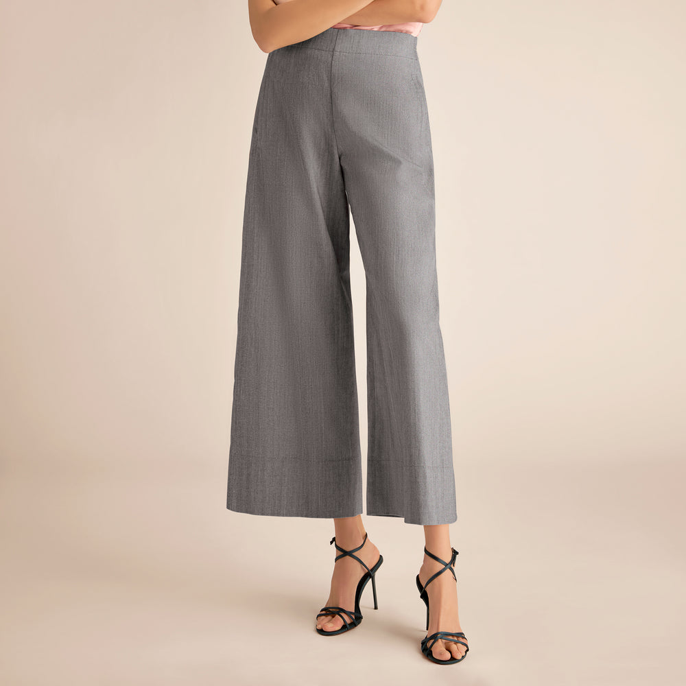 Gray wide-leg pants worn by a person on a beige background