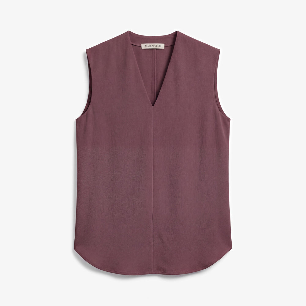 A sleeveless V-neck top in a dusty mauve or plum color, laid flat against a light gray background.