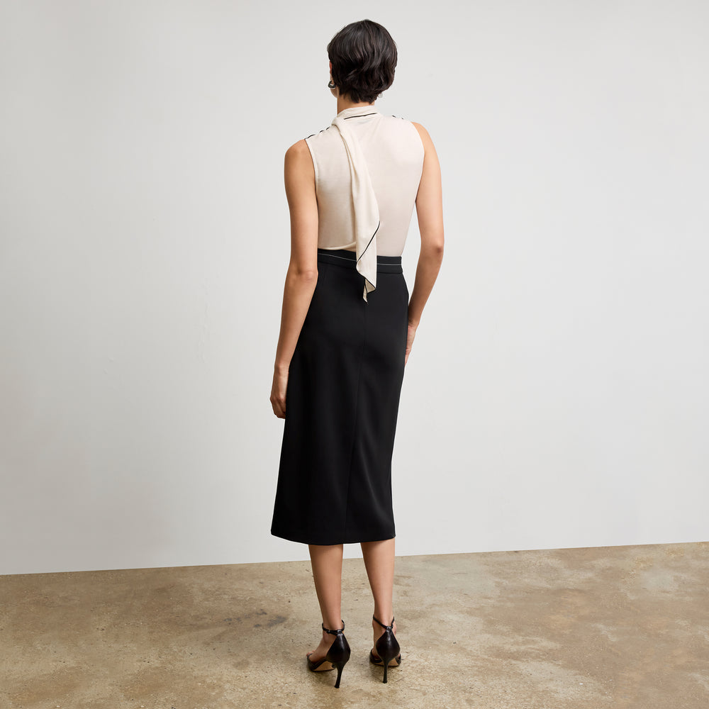 back image of a woman wearing the meghan skirt in black with topstitch