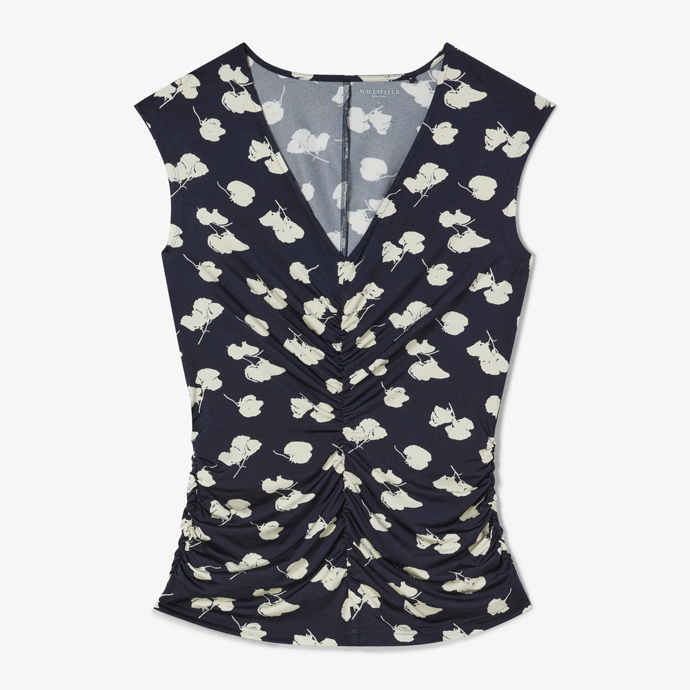 Navy sleeveless top with white floral pattern on a white background