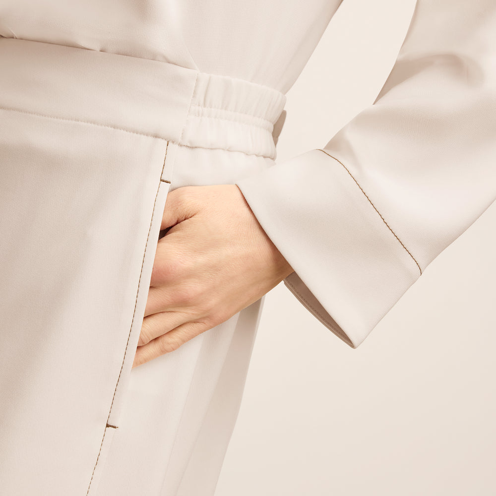 front image of a woman wearing the elena pant in eggshell