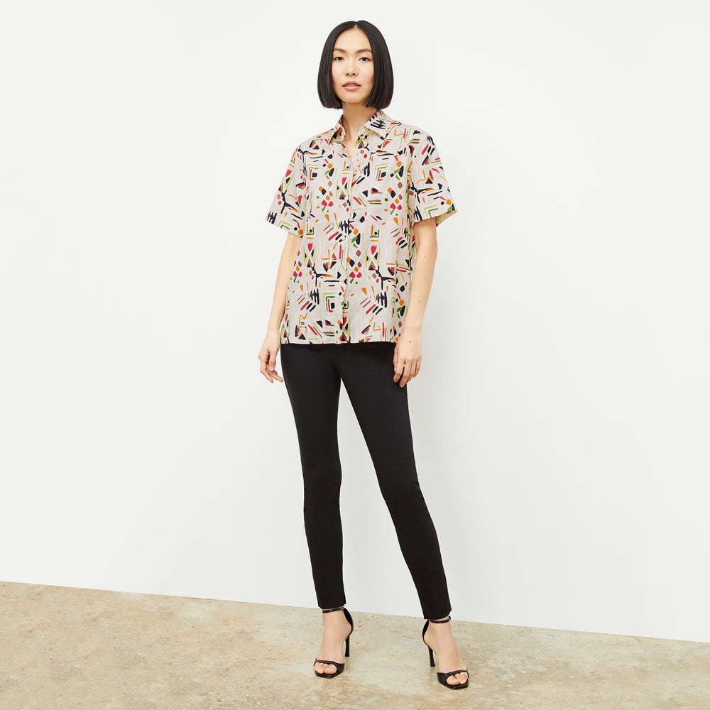 front image of a woman wearing the livingston top in rhythm print