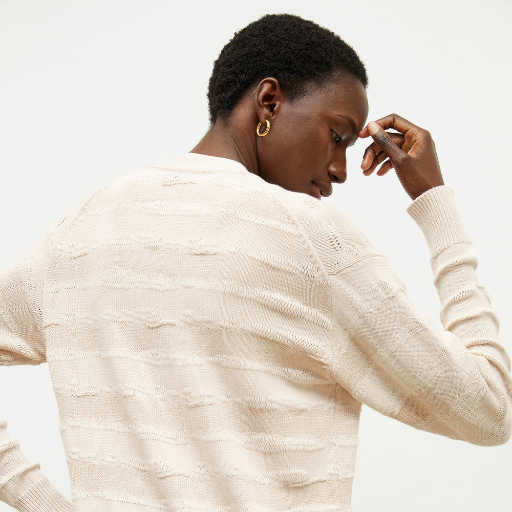 back image of a woman wearing the cookie cardigan in moonbeam