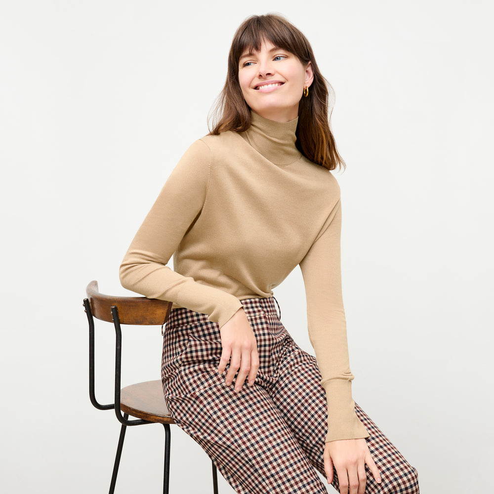 front image of a woman wearing the elizabeth turtleneck in camel