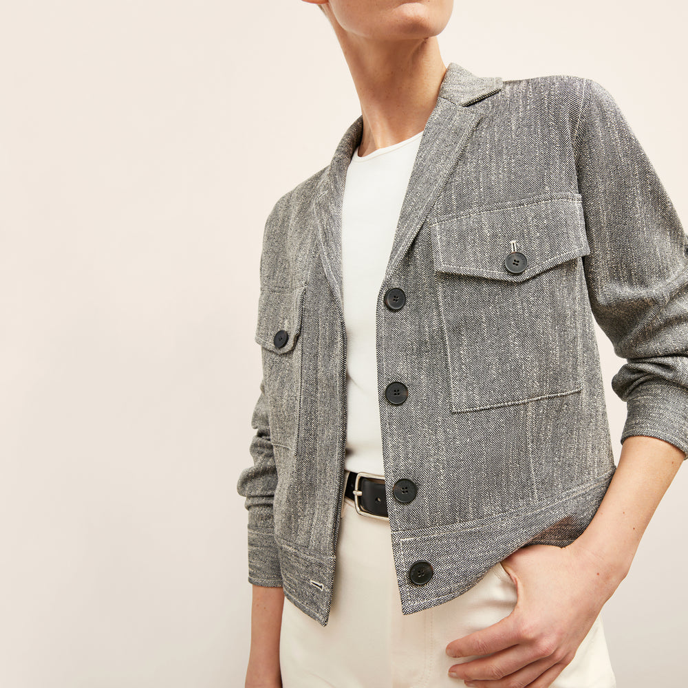 front image of a woman wearing the rhoda jacket in black/ivory