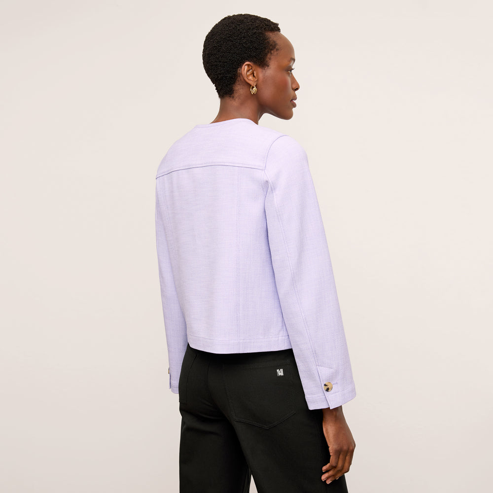 back image of a woman wearing the aniya jacket in lilac/ivory