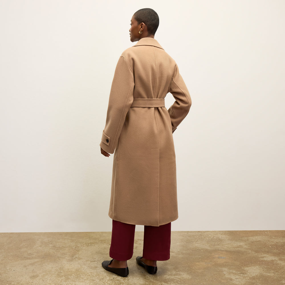 back image of a woman wearing the viola coat in camel