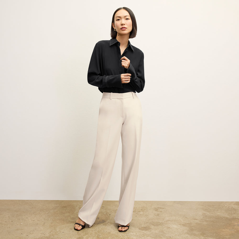 front image of a woman wearing the mira top in black