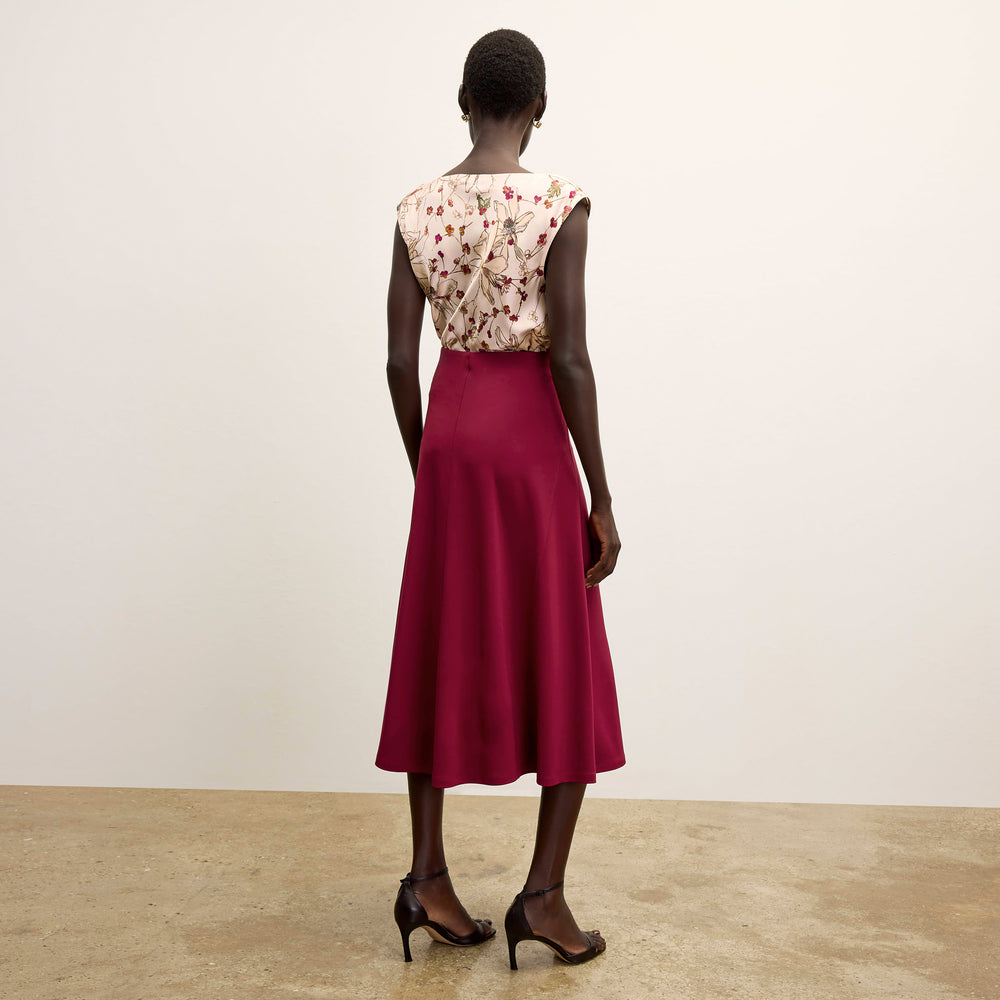 back image of a woman wearing the misty skirt in grenache