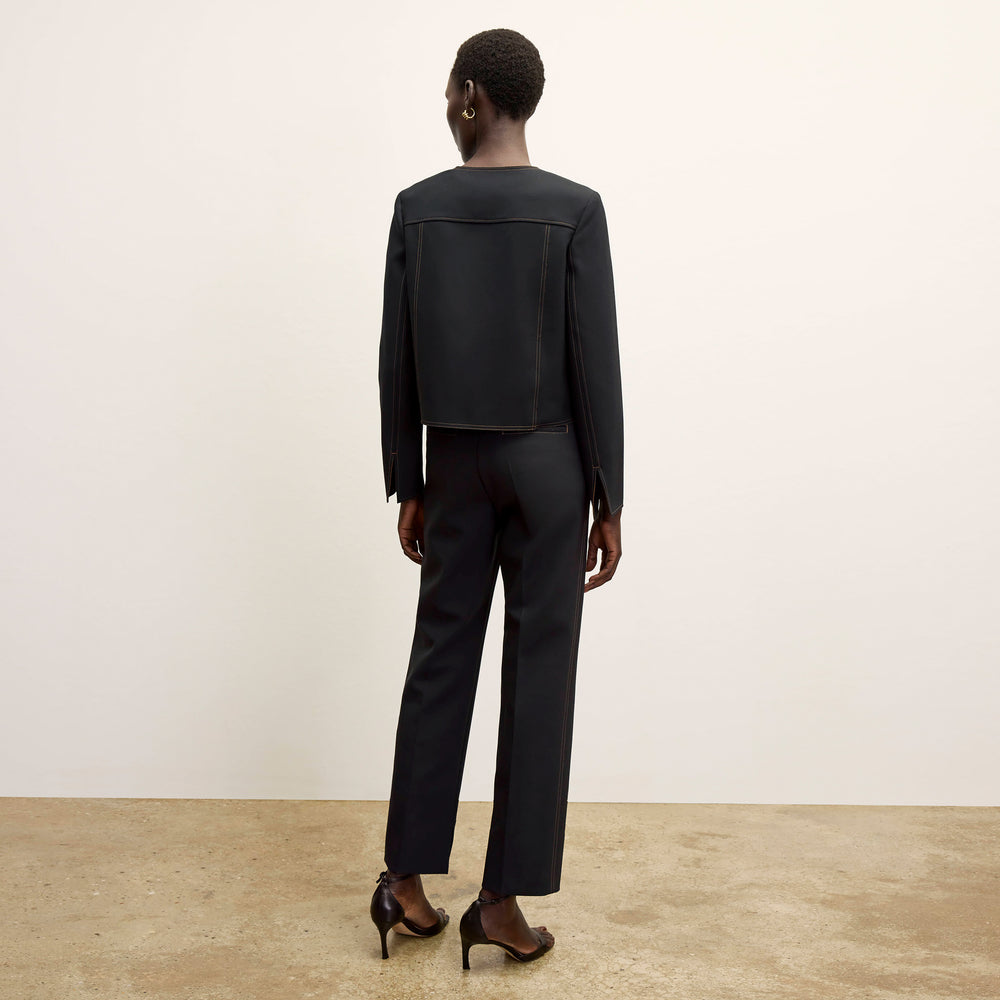 back image of a woman wearing the sella pant in black/light saddle
