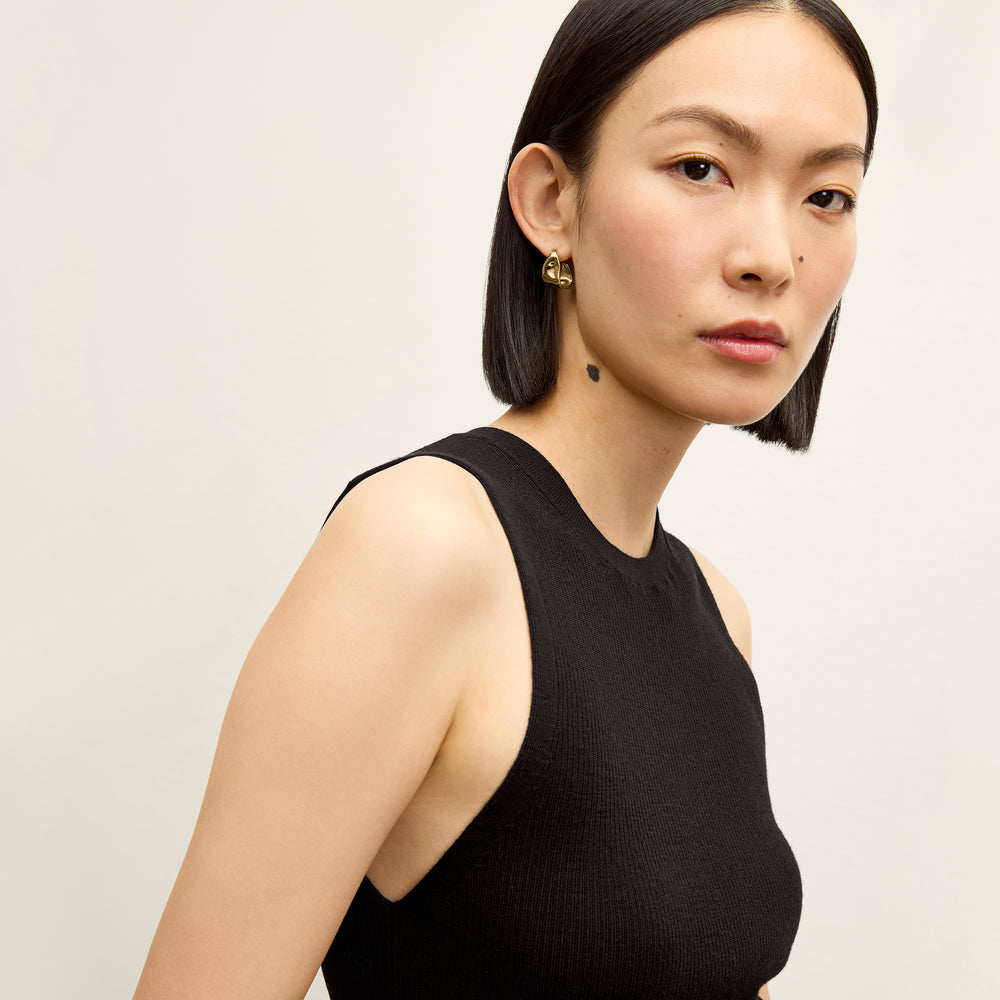front image of a woman wearing the trina top in black