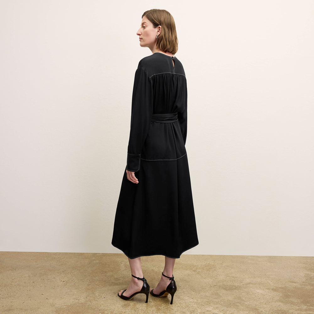back image of a woman wearing the edie dress in black