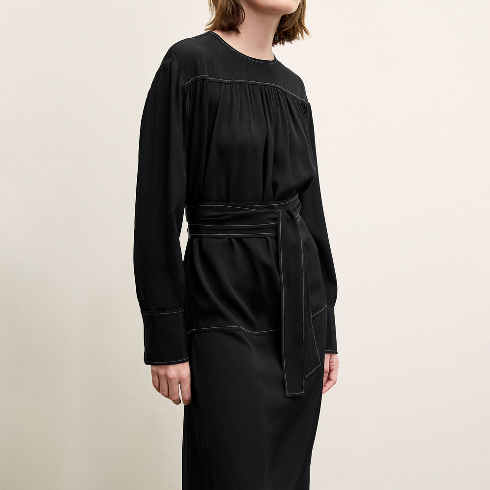 front image of a woman wearing the edie dress in black