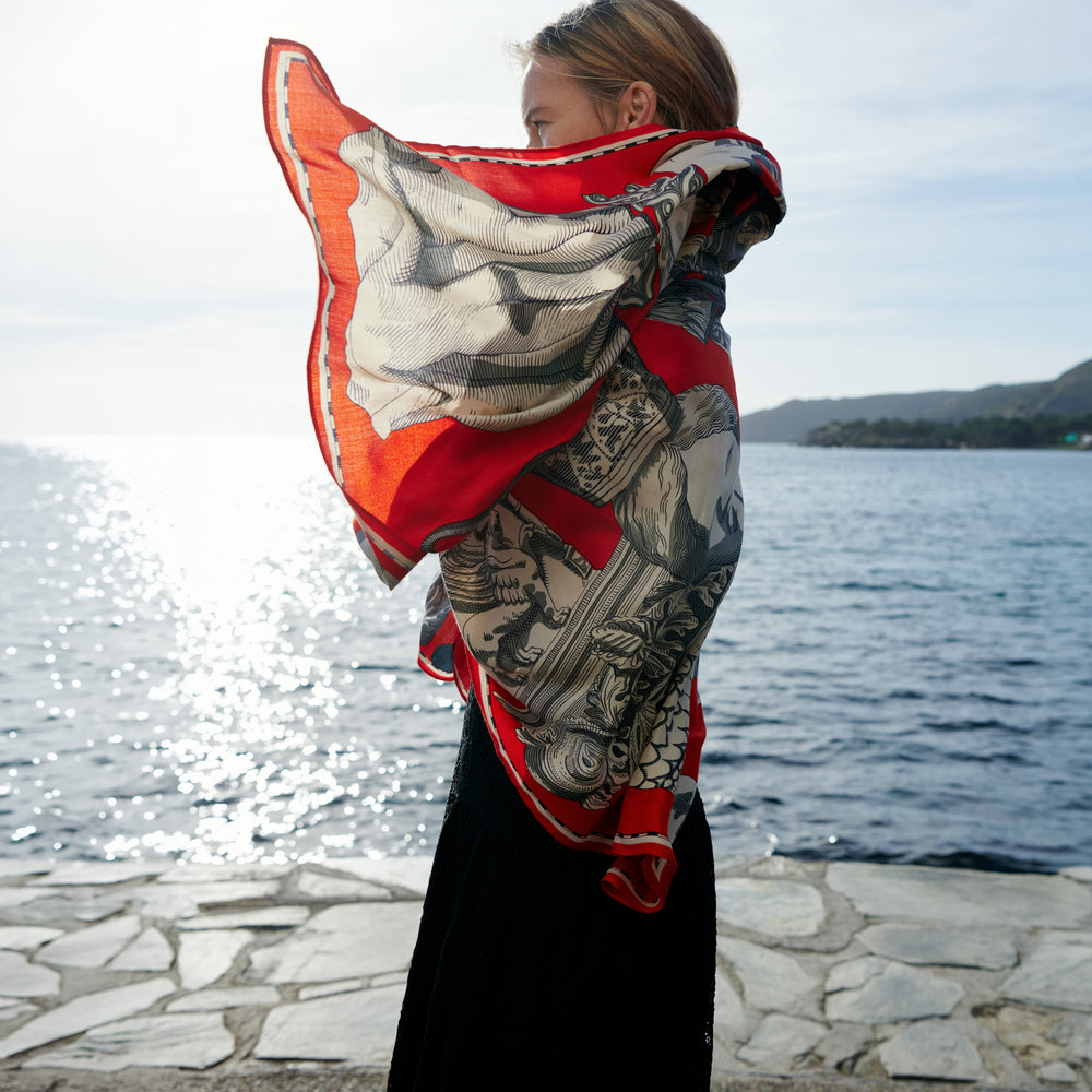 woman in black dress with red scarf.