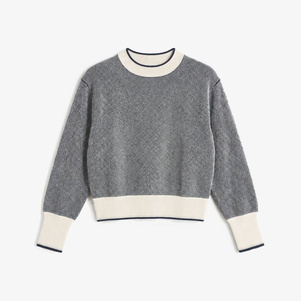 A gray and white textured knit crewneck sweater with cream ribbed collar, cuffs, and hem, displayed flat against a light gray background.