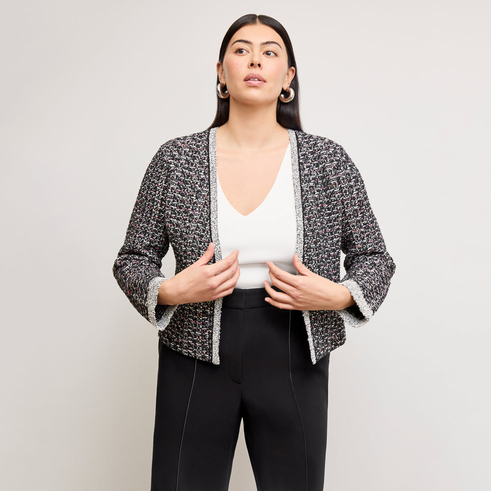 front image of a woman wearing the meena jardigan in boucle tweed black/white