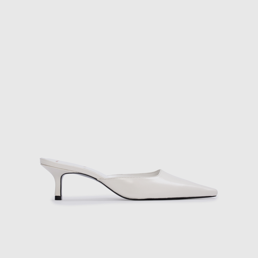 White high-heeled shoe on a light gray background