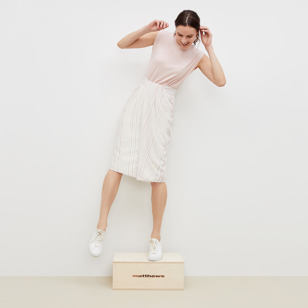 Front image of a woman standing wearing the lenox skirt in twill stripe in ivory / red