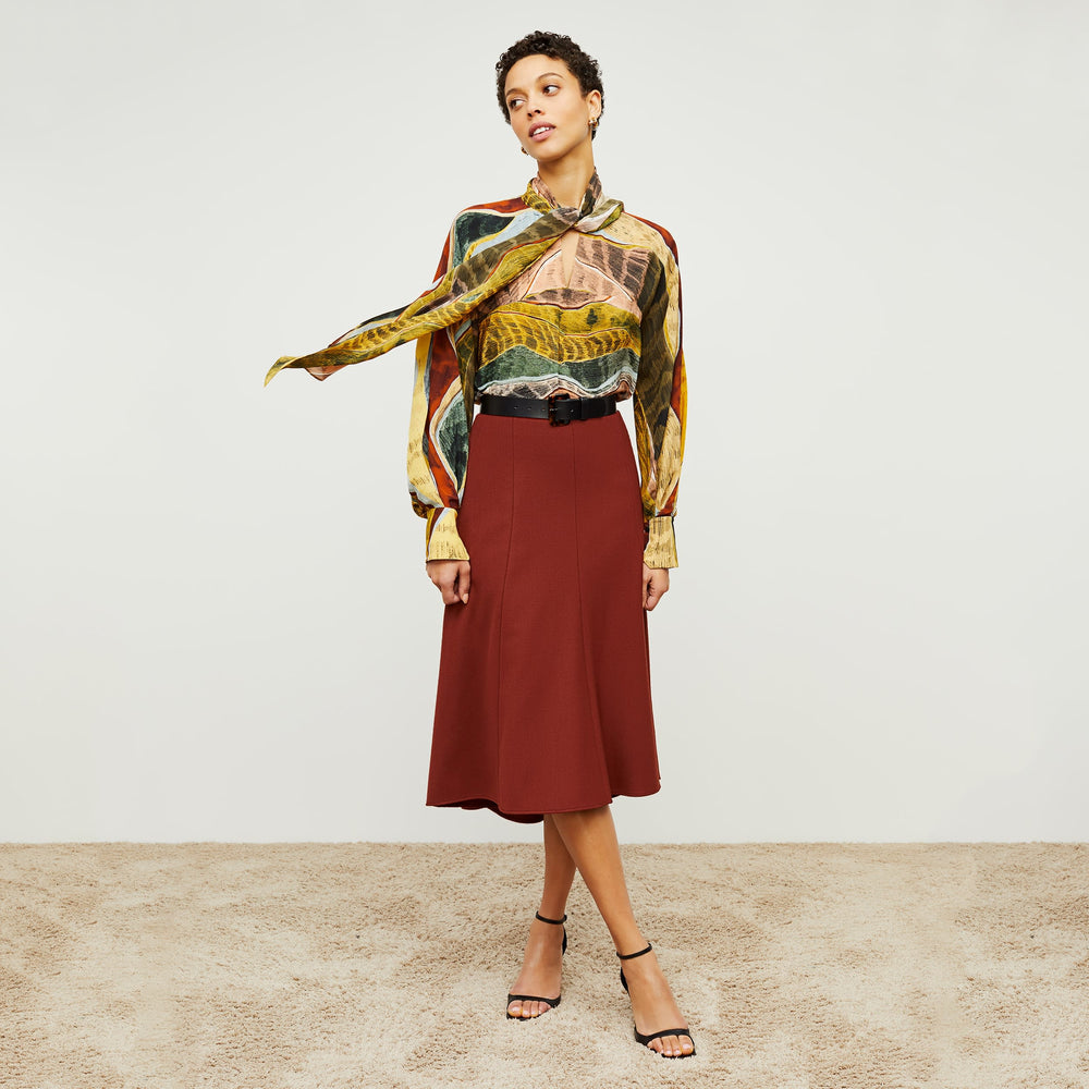 Front image of a woman standing wearing the Fiona TopāSilk Desert in Multicolor