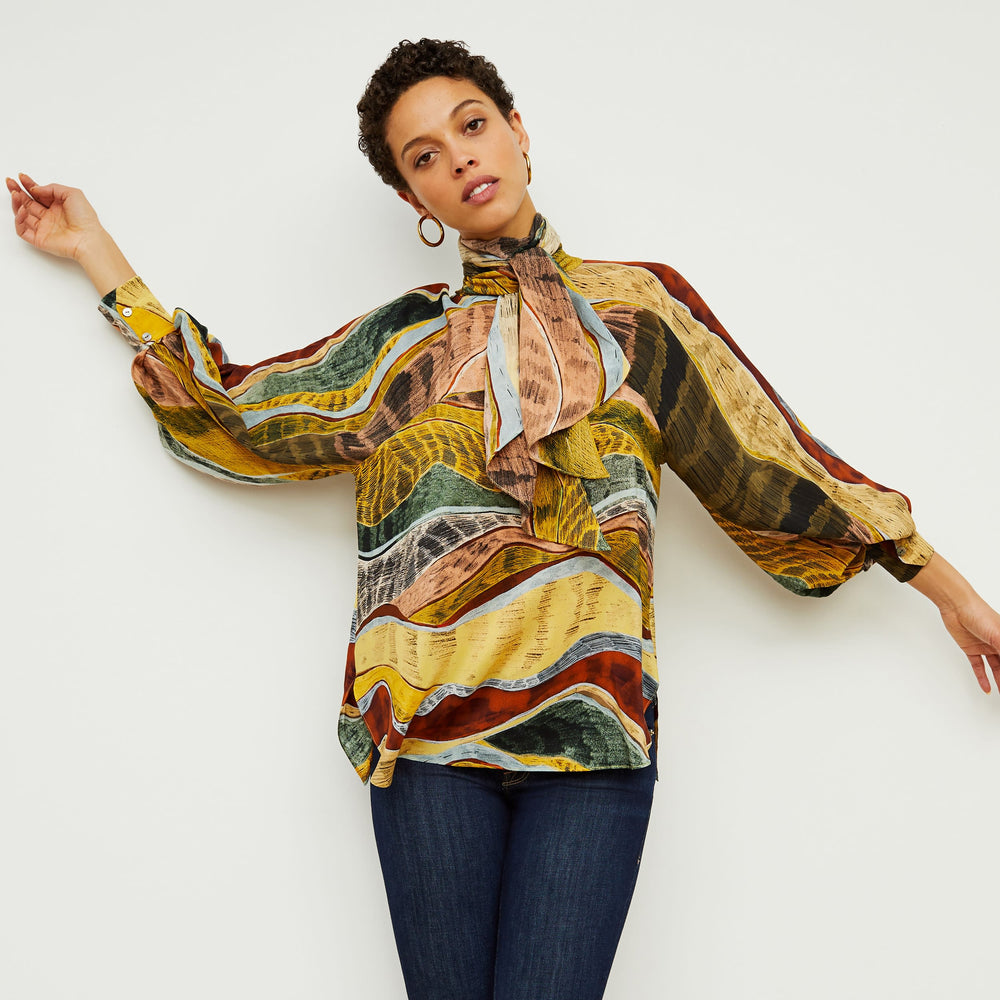 Front image of a woman standing wearing the Fiona TopāSilk Desert in Multicolor