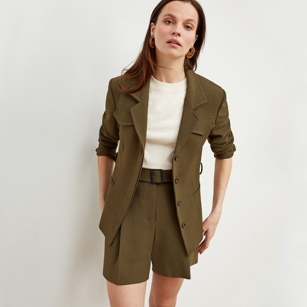 Front image of a woman standing wearing the Fletcher Short—Nep Suiting in Safari