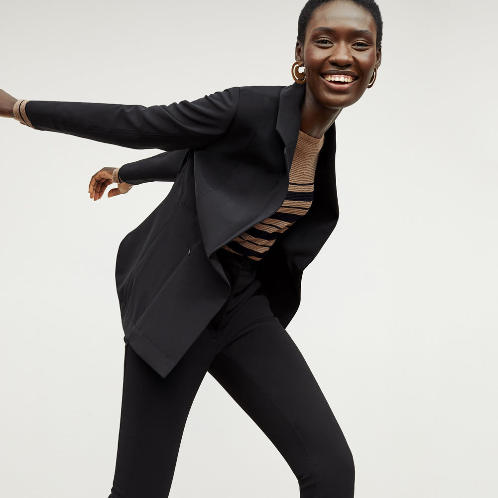 Front image of a woman standing wearing the Samara Sweater—Knit Linen in Oak / Black