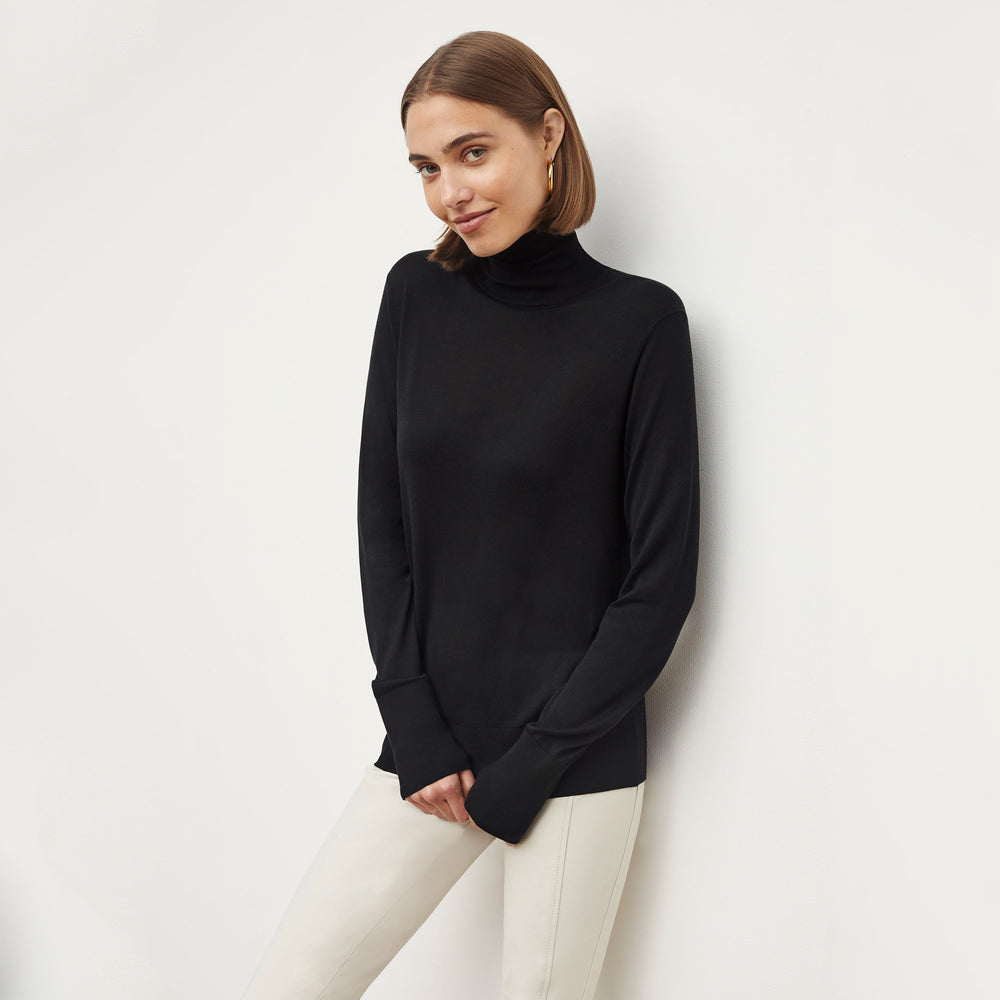 Front image of a woman wearing the elizabeth top in black