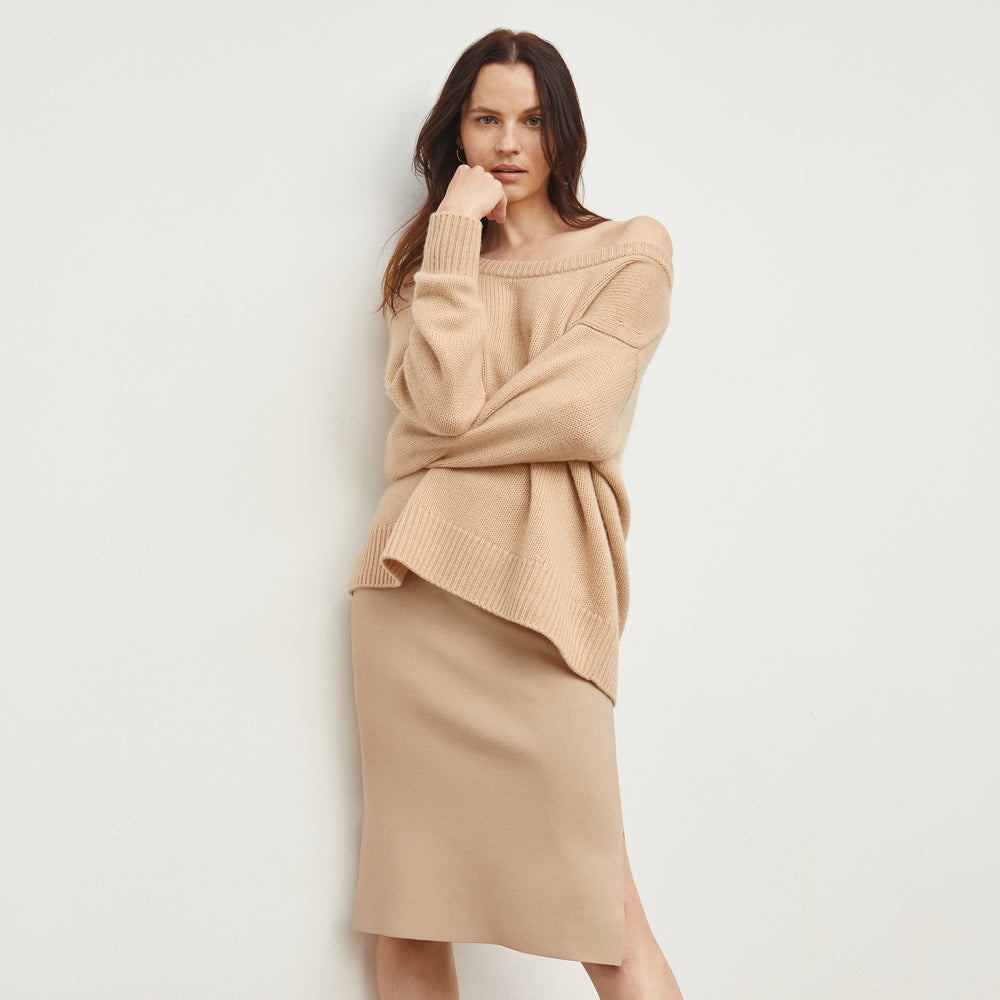 Front image of a woman standing wearing the Harlem skirt in latte