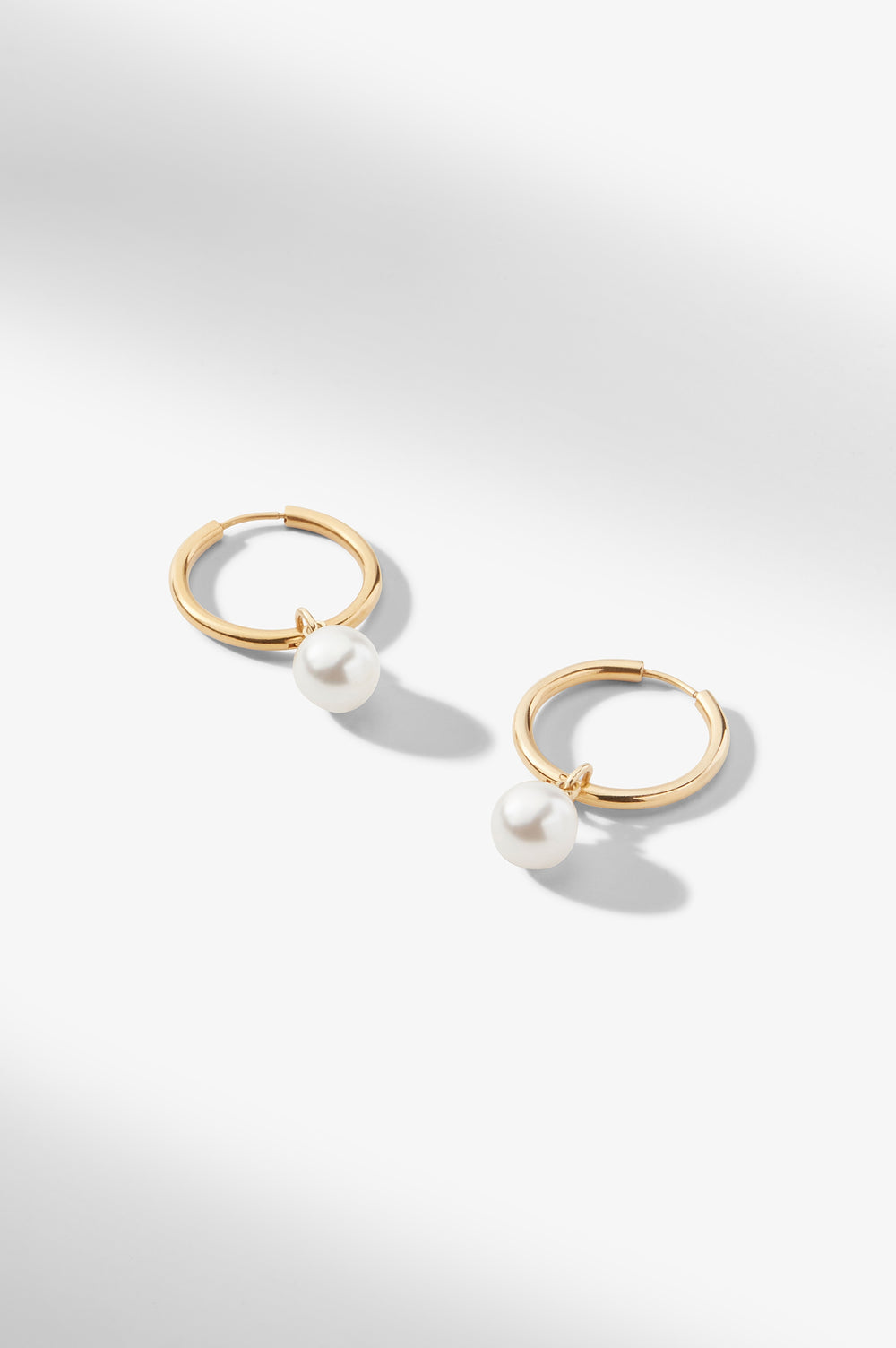 still image of the Claude Charms in Gold on the claressa hoop small in gold