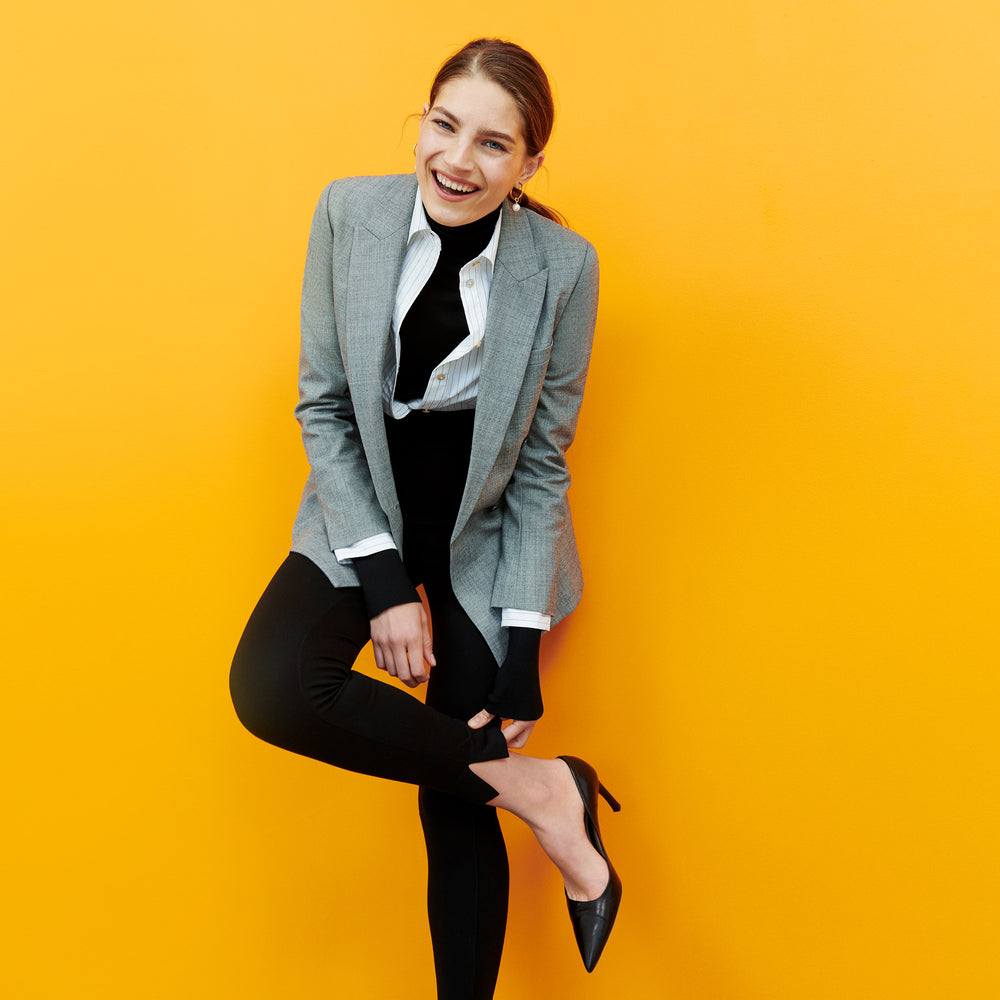 Front image of a woman standing wearing the curie pant in black