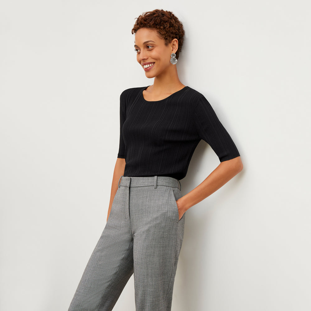 Front image of a woman wearing the Charli top in black
