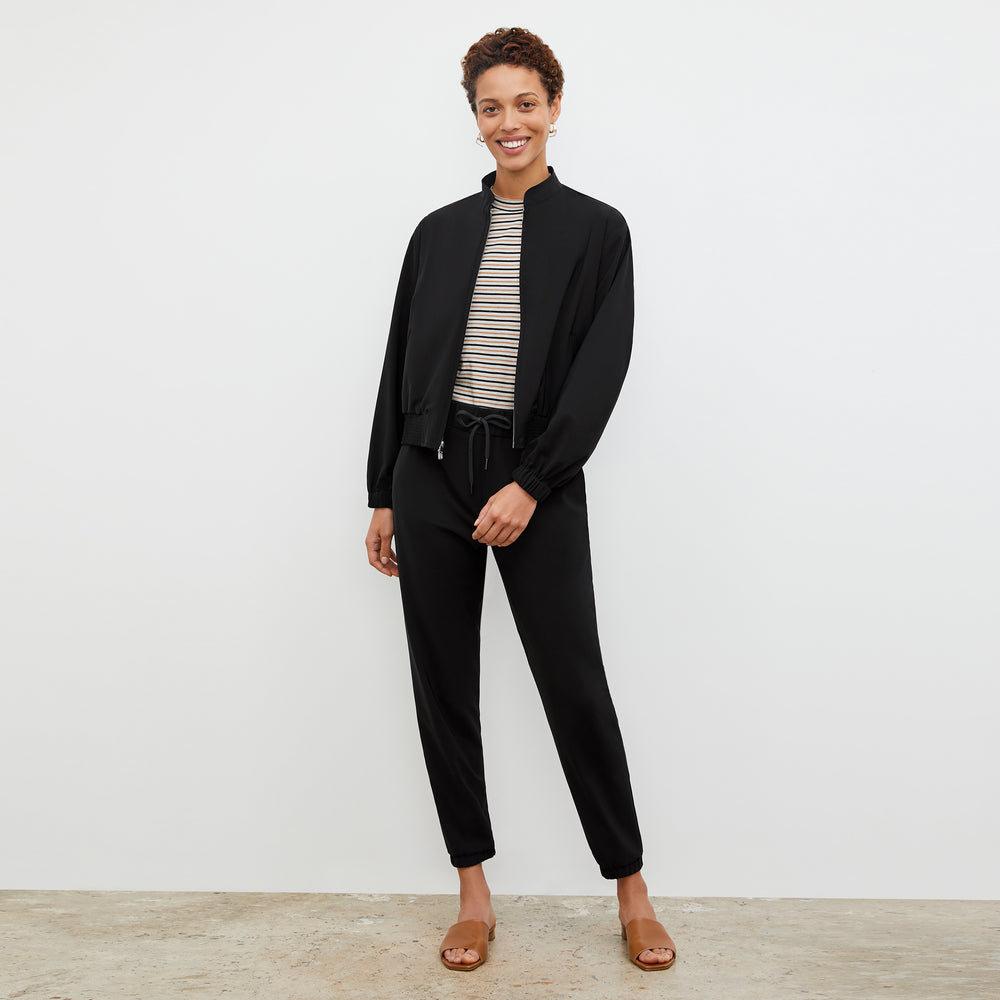 Front image of a woman standing wearing the Delaney Jogger—OrigamiTech in Black
