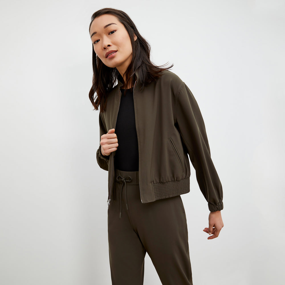 Side image of a woman wearing the Langley Bomber - OrigamiTech in Olive