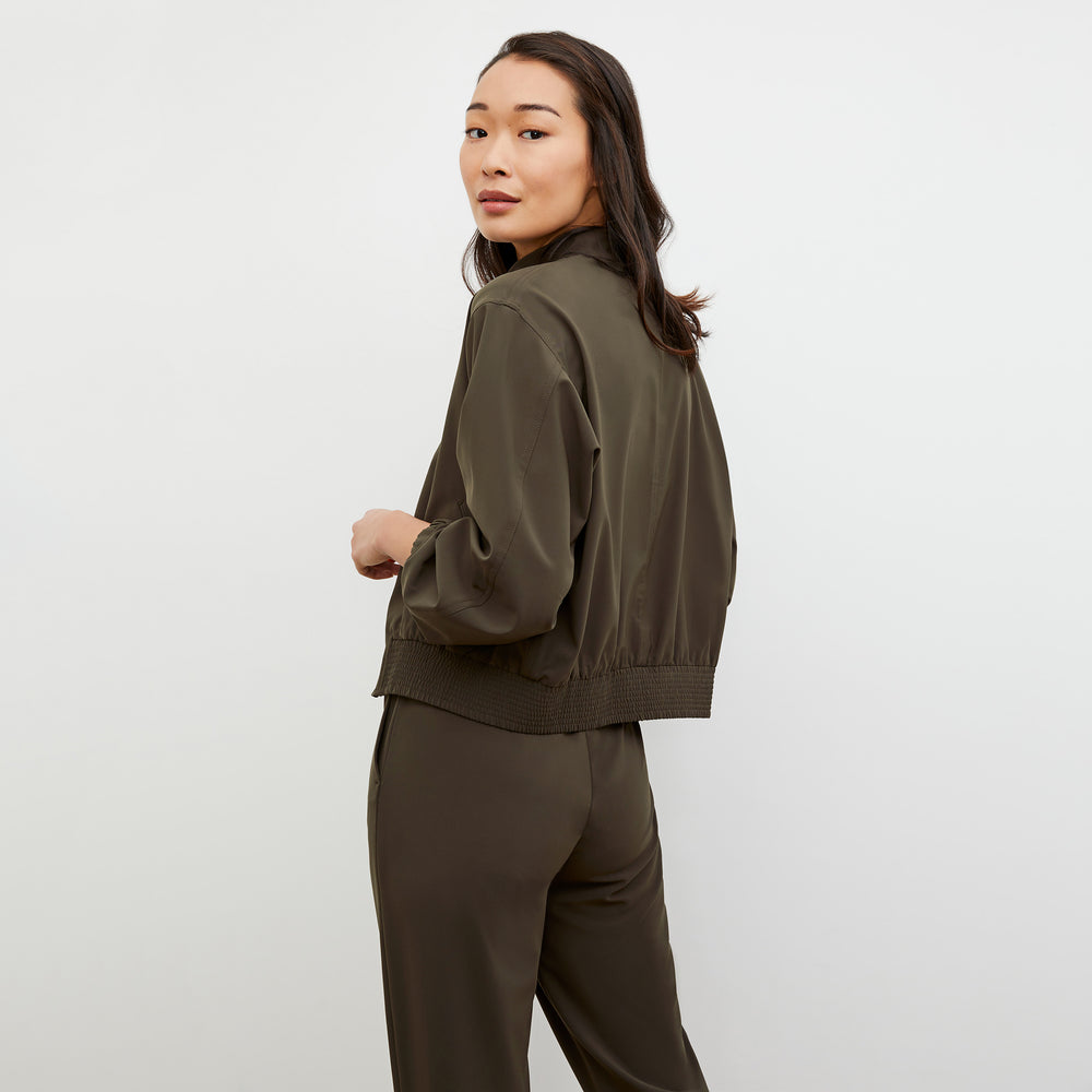 Back image of a woman wearing the Langley Bomber - OrigamiTech in Olive