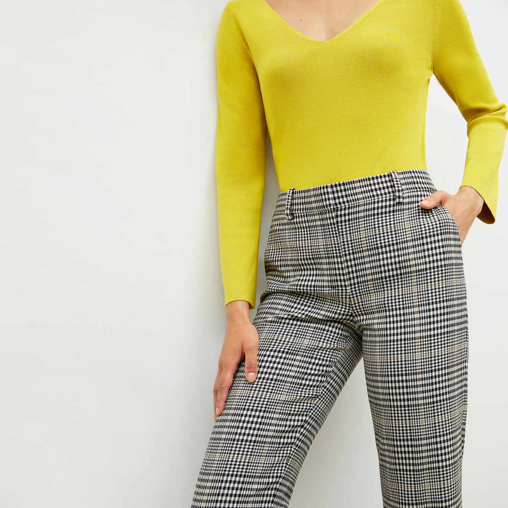 Front image of a woman wearing the kara top in chartreuse