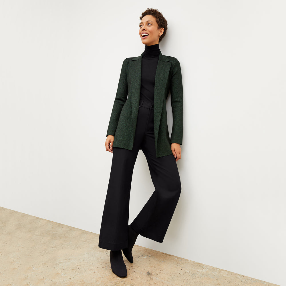 Front image of a woman wearing the elizabeth top in black