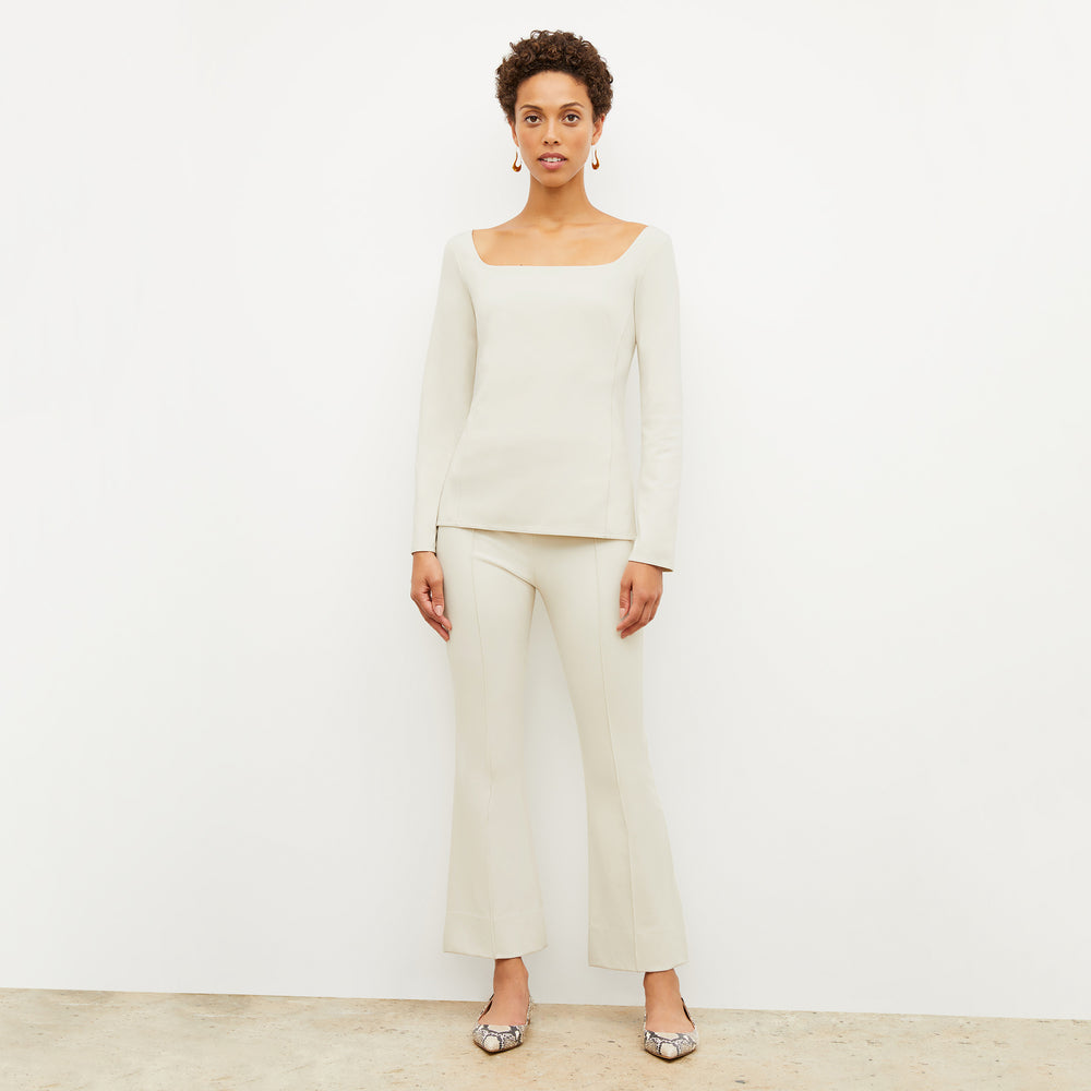 Front image of a woman wearing the jace top in pearl